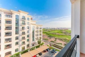 a view from a balcony of a building at Golf Course View, Stylish 2 Bedroom in Al Qurayyah