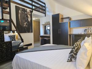 a bedroom with a large bed and a tv at TheLine in Bucharest