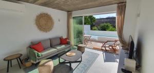 a living room with a couch and a tv at Lemon Villa in Lagos