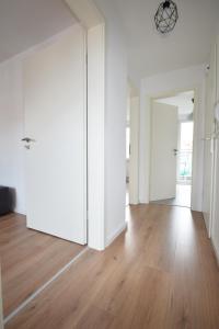 an empty room with white walls and wooden floors at Air Apartments 5 in Bremen