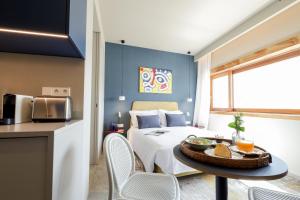 a bedroom with a bed and a table with a tray of food on it at Aspasios Bonjardim Apartments in Porto