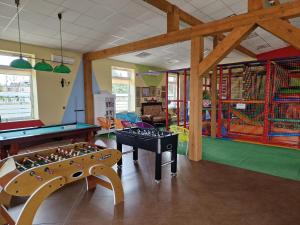 a childrens play room with a pool table and foosball at D.W.KaMil in Łeba