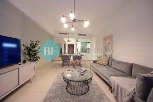 a living room with a couch and a tv at Luxury 2 Bedroom In Reem Island in Abu Dhabi