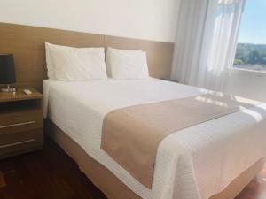 Cama ou camas em um quarto em Grande Hotel Amparo