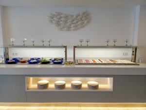 a display case with plates and bowls on a counter at Apartamentos Cordial Magec Taurito in Taurito