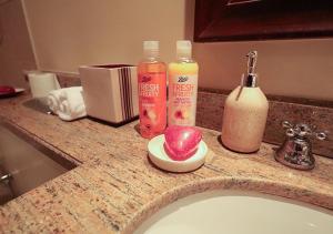 a bathroom counter with a sink and two bottles of soap at MH- Beautiful One Bedroom - Burj View - Zanzebeel 2 Ref 210B in Dubai +9 photos