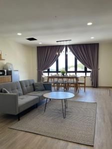 a living room with a couch and a table at Utopia Homestay @ Cameron Centrum in Cameron Highlands