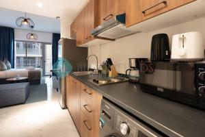a kitchen with a counter top and a microwave at Premium Studio In Oasis in Abu Dhabi