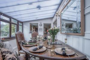 a dining room with a table and a mirror at Angel Cottage - 3 Bedroom Cottage - Stepaside in Stepaside