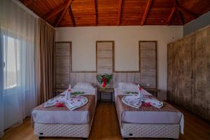 a room with three beds in a room at Senza Garden Holiday Club - Ultra All Inclusive in Konaklı
