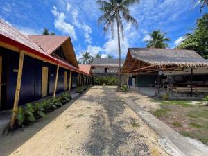 a building with palm trees in the background at Dawn Patrol Siargao in General Luna