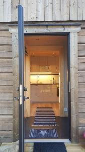 uma porta que leva a uma cozinha numa casa em UTSIKTEN -exklusivt nybyggt timmerhus -Plintsberg. em Tällberg