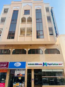 a tall building with a sign in front of it at Marhaba Deira Hotel in Dubai