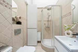 a bathroom with a shower and a toilet and a sink at Cracovian House - LoftAffair in Kraków