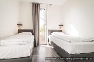 En eller flere senge i et værelse på Vakantiepark De Krim Texel