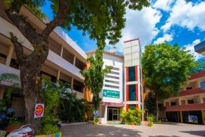 a building with a tree in front of it at Hotel TamilNadu - Madurai I in Madurai