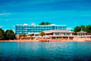 a large blue building next to a body of water at Courtyard by Marriott Hannover Maschsee in Hannover