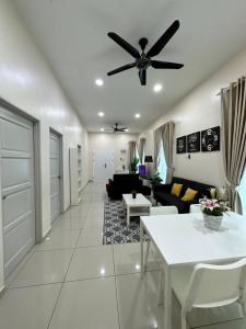 a living room with a ceiling fan and a table at RumahKu Homestay, Taman Jasin Perdana in Jasin +28 photos