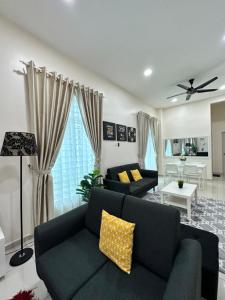 uma sala de estar com um sofá e uma mesa em RumahKu Homestay, Taman Jasin Perdana em Jasin