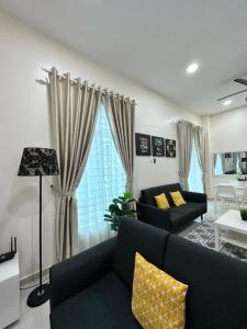 a living room with a couch and a table at RumahKu Homestay, Taman Jasin Perdana in Jasin +28 photos
