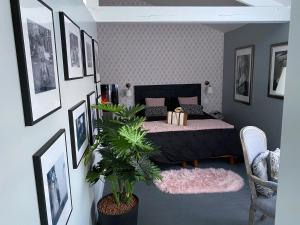 a bedroom with a bed and pictures on the wall at Parker et Tammy in Saint-Gelais