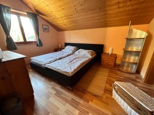 a bedroom with a bed and a wooden ceiling at Haus Susi in Dornbirn