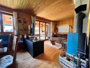 a living room with a couch and a stove at Haus Susi in Dornbirn