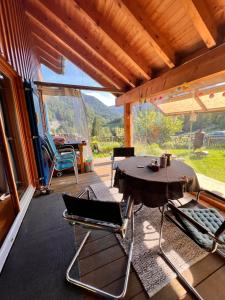 ein Esszimmer mit einem Tisch und Stühlen auf einer Veranda in der Unterkunft Haus Susi in Dornbirn