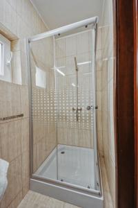 a shower with a glass door in a bathroom at Complex Turistic Constantin Bucovina in Câmpulung Moldovenesc
