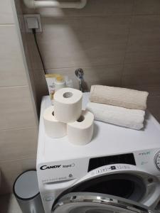 a pile of toilet paper sitting on top of a washing machine at EDIK in Velika Gorica
