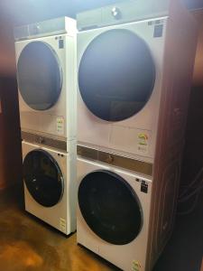 two washing machines are standing next to each other at Good Guesthouse #2 in Seoul