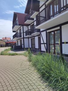 a building with balconies on the side of it at Apartamenty Bulwar Nadmorski, Rowy in Rowy