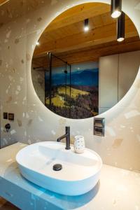 a bathroom with a sink and a mirror at Osada Miód Malina in Istebna