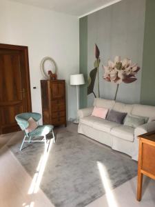 a living room with a couch and a chair at Casa Tesor - your design home in Mantua city center in Mantova