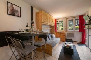 a living room with a table and a couch at Chamonix Sud - Jonquilles 30 - Happy Rentals in Chamonix-Mont-Blanc