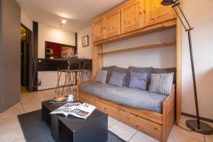 a living room with a couch with a bunk bed at Chamonix Sud - Jonquilles 30 - Happy Rentals in Chamonix-Mont-Blanc