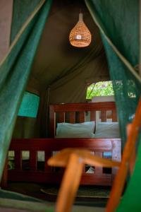 a bedroom with a bed in a tent at Mikadi Beach Camp & Backpackers in Dar es Salaam