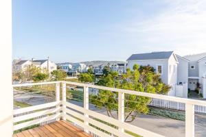 a balcony with a white railing and a view of a city at Peaceful Parkland Home on Thesen Islands in Knysna