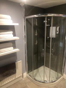 a glass shower in a bathroom with towels at Stunning Sea view apartment absolute top quality 100s of 5 star reviews You will not be disappointed in Widows Row