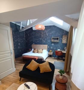 a living room with a bed and a couch at Logis Hôtel Restaurant La Breche in Amboise