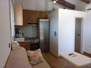 a small kitchen with a stainless steel refrigerator at Casa vistas inmejorables in Caserío Carraspite