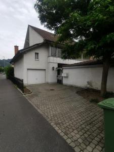 a large white house with a brick driveway at NEB-Thun Haus in Thun für 8 Pax in Thun