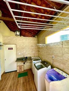 a laundry room with a washer and dryer in it at AP1 Atrás da passarela do caranguejo - Orla de Atalaia in Aracaju