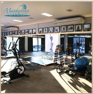 a gym with treadmills and elliptical machines at Apartamento Manhattan Beach Riviera in Aquiraz