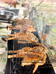 a grill with a bunch of food on it at Tam Coc Rocky Bungalow in Ninh Binh