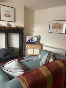 a living room with a couch and a television at No.18 Holmfirth in Holmfirth