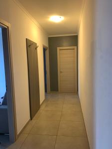 a hallway with a door and a tile floor at Raggio di Sole in San Cesareo