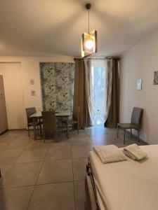 a room with a bed and a table and chairs at Raggio di Sole in San Cesareo