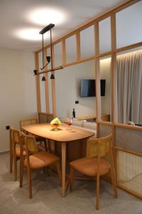 uma sala de jantar com uma mesa de madeira e cadeiras em Paligremnos Infinity em Plakiás