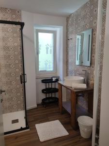 a bathroom with a sink and a mirror at Casa Pitem in Nago-Torbole